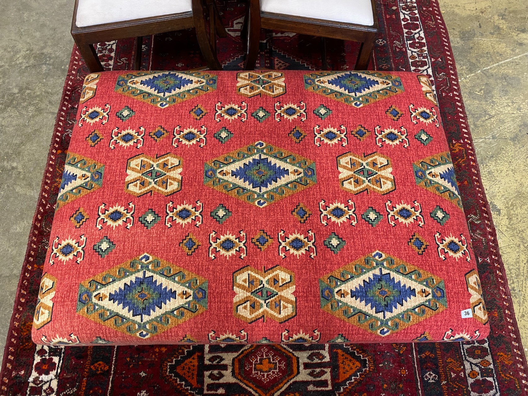 A large rectangular contemporary footstool upholstered in Kilim style fabric, length 122cm, depth 90cm, height 28cm